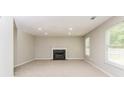 Spacious living room with plush carpet, a fireplace, neutral colors, and bright, natural light at 2743 High Tide Dr, Atlanta, GA 30349