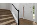 Inviting entryway features hardwood floors, carpeted stairs, and a bright white front door at 1620 Concord Meadows Dr, Smyrna, GA 30082