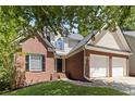 Traditional two-story brick home features attached two-car garage and lovely landscaping at 1620 Concord Meadows Dr, Smyrna, GA 30082