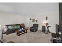 Comfortable living room with plush seating, carpet, and neutral walls at 5868 Ash St, Forest Park, GA 30297