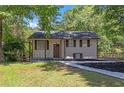 Charming home featuring a well maintained front yard, black roof, and brown trim at 2496 Shiloh Dr, Decatur, GA 30034