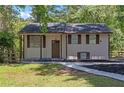 Charming home featuring a well maintained front yard, black roof, and brown trim at 2496 Shiloh Dr, Decatur, GA 30034