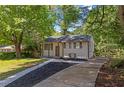 Charming home featuring a well maintained front yard, black roof, and brown trim at 2496 Shiloh Dr, Decatur, GA 30034