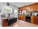 Functional kitchen with tile backsplash, wooden cabinets and a breakfast bar at 4361 Kimball Rd, Atlanta, GA 30331