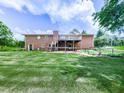 Beautiful backyard view showcasing a brick home with a deck and a spacious grassy area at 104 Cochran Ridge Rd, Dallas, GA 30157