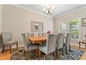 Bright dining room with hardwood floors, stylish rug, and a chandelier, perfect for Gathering gatherings at 1201 Bridle Path, Marietta, GA 30068