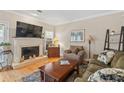 Cozy living room with a fireplace, hardwood flooring, and comfortable seating at 1201 Bridle Path, Marietta, GA 30068