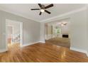 Open-concept living room with hardwood floors, a cozy fireplace, and abundant natural light at 1502 Lake Koinonia Dr, Woodstock, GA 30189