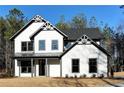 Charming two-story home with board and batten siding, covered entry and dark trim accents at 3785 Pilgrim Mill Rd, Cumming, GA 30041