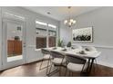 Elegant dining room with a marble table, stylish chairs, modern light fixture, and sliding glass doors to a small patio at 4965 Whiteoak Se Walk # 19, Smyrna, GA 30080