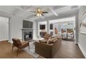 Cozy living room features a fireplace, coffered ceilings, modern furniture, and an open concept layout with a dining area and kitchen at 4965 Whiteoak Se Walk # 19, Smyrna, GA 30080