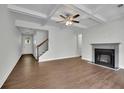 Inviting living room with hardwood floors, fireplace, coffered ceiling, and stairs leading to upper level at 4965 Whiteoak Se Walk # 19, Smyrna, GA 30080