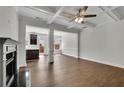 Bright living room featuring hardwood floors, a ceiling fan, and a fireplace with dark wood trim at 4965 Whiteoak Se Walk # 19, Smyrna, GA 30080