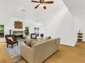 Bright and airy living room features a stone fireplace, ceiling fan, and light hardwood floors at 1997 N Landing Way, Marietta, GA 30066