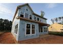Exterior view of an unfinished two-story home showcasing its structure under construction at 4720 Briscoe Dr, Cumming, GA 30028