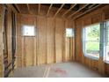 Spacious interior showing bare framing, windows, and essential utility runs, highlighting the construction phase at 4720 Briscoe Dr, Cumming, GA 30028