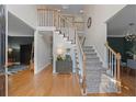 Bright and spacious foyer features hardwood floors, a staircase, and views into adjacent living spaces at 5028 Winding Hills Ln, Woodstock, GA 30189