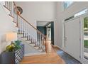 Elegant foyer with a high ceiling, hardwood floors, staircase, and stylish decor at 5028 Winding Hills Ln, Woodstock, GA 30189
