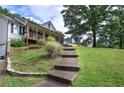 Beautiful home with a landscaped yard, stone steps leading to the front entrance, and mature trees at 527 Cass White Nw Rd, Cartersville, GA 30121