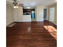 A spacious living room features hardwood floors and a view into the modern kitchen with stainless steel appliances at 1202 Santa Fe Pkwy, Atlanta, GA 30350