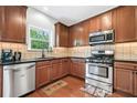 Well-equipped kitchen with stainless steel appliances and wooden cabinetry at 1925 Piedmont Cove Ln, Cumming, GA 30040