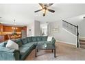 Open-concept living room showcasing a seamless flow into the kitchen and staircase at 1925 Piedmont Cove Ln, Cumming, GA 30040