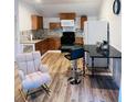 Bright kitchen featuring wood cabinets, a black countertop, and a comfortable rocking chair at 2021 Moody Drive Southwest, Atlanta, GA 30315