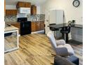 Well-lit kitchen with wooden cabinets, a black countertop, and a comfortable rocking chair nearby at 2021 Moody Drive Southwest, Atlanta, GA 30315