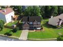Aerial view of brick home, showcasing the landscaped yard and driveway at 5281 Tormeall Trce, Suwanee, GA 30024