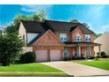 Beautiful brick home with lush green lawn and a spacious driveway at 5281 Tormeall Trce, Suwanee, GA 30024