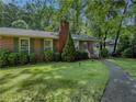 Lovely brick home featuring green shutters, a brick chimney, and a walkway at 664 Mcburnette Ne Rd, Marietta, GA 30068
