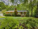Beautiful brick house with a mature tree, lush lawn, and inviting walkway at 664 Mcburnette Ne Rd, Marietta, GA 30068