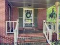 Covered front porch with brick steps and decorative wreath on the door at 664 Mcburnette Ne Rd, Marietta, GA 30068