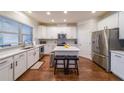 Modern white kitchen with stainless steel appliances and a center island with seating at 991 Sibley Ne Ln, Atlanta, GA 30324