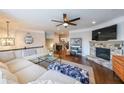 Inviting living room features stone fireplace, hardwood floors, and large sectional couch at 991 Sibley Ne Ln, Atlanta, GA 30324