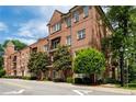 Charming brick condo building with balconies and tree-lined street at 351 Washington Ne Ave # 205, Marietta, GA 30060