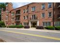 Classic brick building with manicured landscaping and elegant entrance at 351 Washington Ne Ave # 205, Marietta, GA 30060