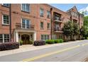 Beautiful brick condo building with arched entryway and manicured bushes at 351 Washington Ne Ave # 205, Marietta, GA 30060