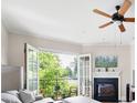 Inviting living room boasts a fireplace, ceiling fan, and balcony with scenic views at 351 Washington Ne Ave # 205, Marietta, GA 30060