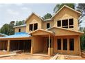New construction showcases the unfinished exterior framing of this modern two-story home at 4835 Beechnut Circle, Cumming, GA 30028