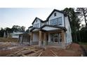 View of exterior featuring white siding, dark trim, and a stone-accented porch of new construction home at 4835 Beechnut Circle, Cumming, GA 30028