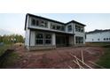 Rear of two-story new home construction featuring a large backyard, siding, and multiple windows at 4835 Beechnut Circle, Cumming, GA 30028