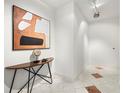 Clean hallway with patterned tile flooring, a decorative table, and modern art at 905 Juniper Ne St # 708, Atlanta, GA 30309