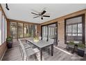 Cozy sunroom with wood paneling, a ceiling fan, and a large dining table for enjoying meals at 3193 Deshong Dr, Stone Mountain, GA 30087
