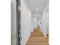 Bright hallway features wood flooring, white trim, and neutral paint, providing an open feel at 401 Village Ln, Fairburn, GA 30213