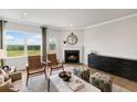 Bright living room with fireplace, hardwood floors, and large windows with scenic view at 401 Village Ln, Fairburn, GA 30213