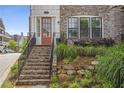 Inviting entrance with stone steps and wrought iron railing leading to a warm wooden door at 392 Concord St, Alpharetta, GA 30009