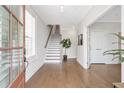 Light-filled foyer with hardwood floors, staircase, and neutral decor showcasing modern elegance at 392 Concord St, Alpharetta, GA 30009