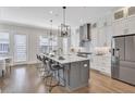 Bright kitchen featuring a large island, stainless steel appliances, and stylish pendant lighting at 392 Concord St, Alpharetta, GA 30009