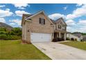 Side view of a brick two-story home with a well-manicured lawn and a driveway at 4832 Stone Way Path, Buford, GA 30519